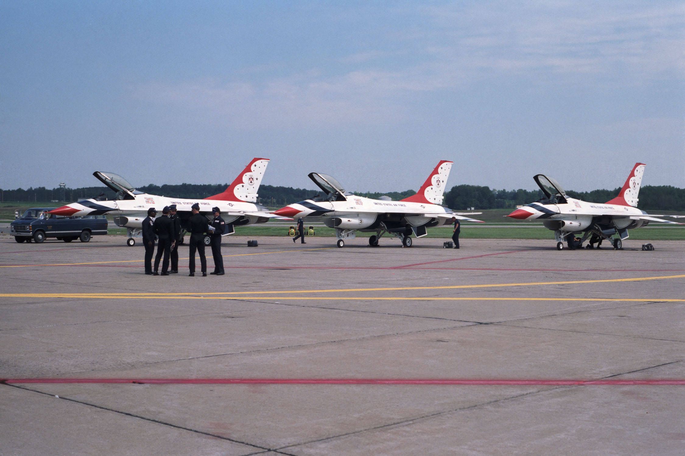 An airfield with airplanes and military personnel